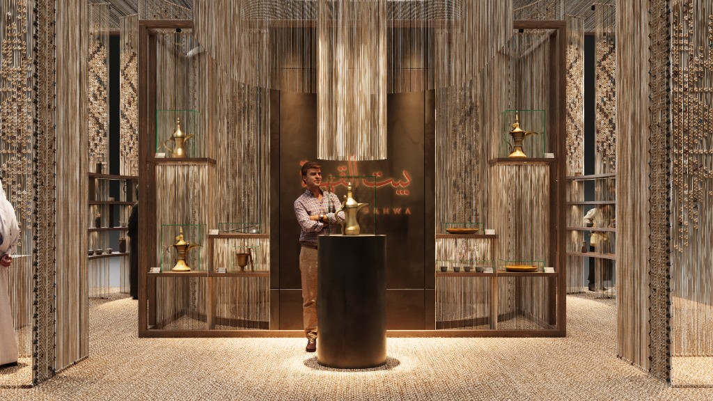 Bait Al Gahwa — central dallah on a plinth with heritage pieces in vitrines
