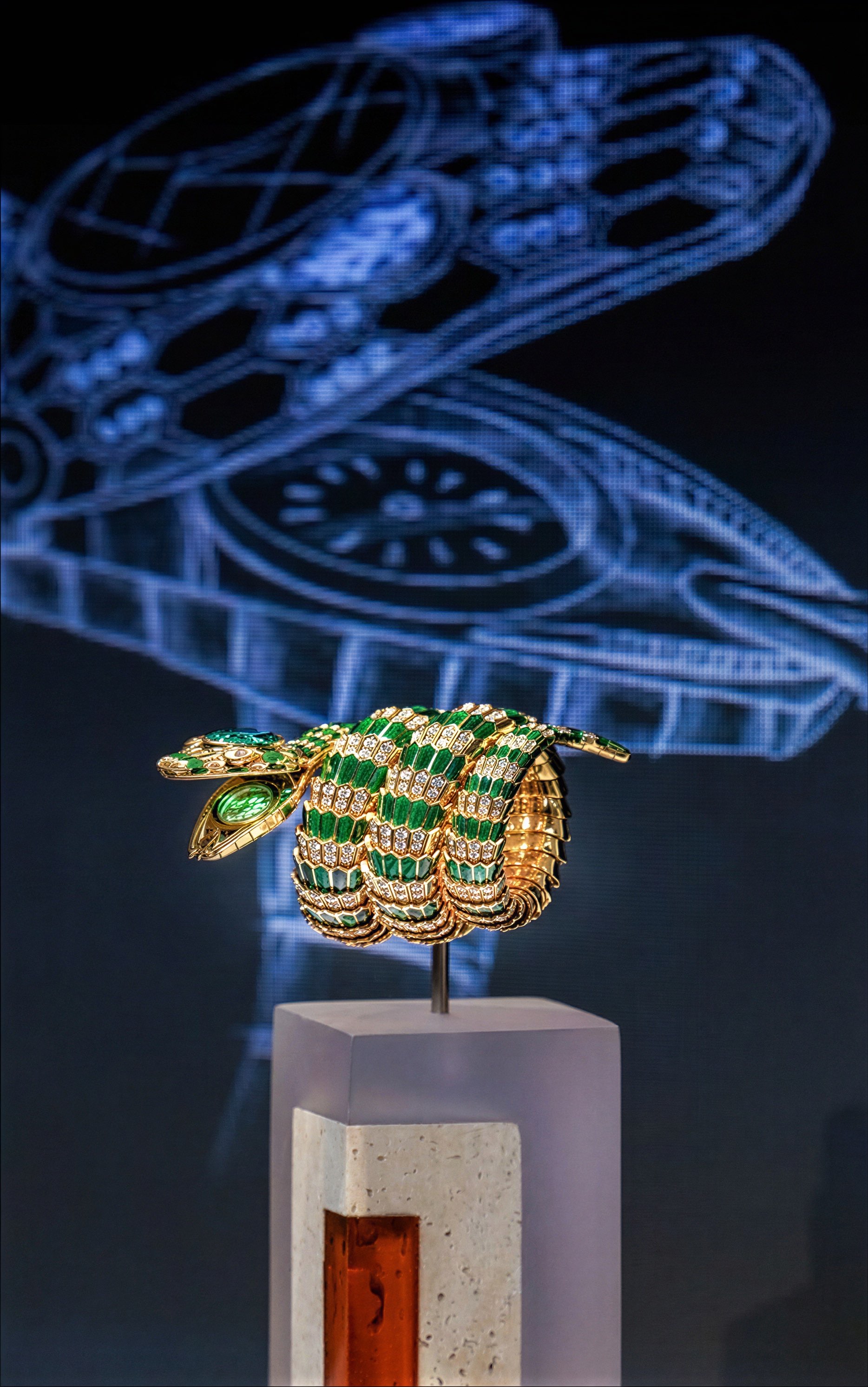 Human as a Catalyst — Serpenti high jewellery bracelet on a plinth in front of the curved LED screen showing a wireframe serpent