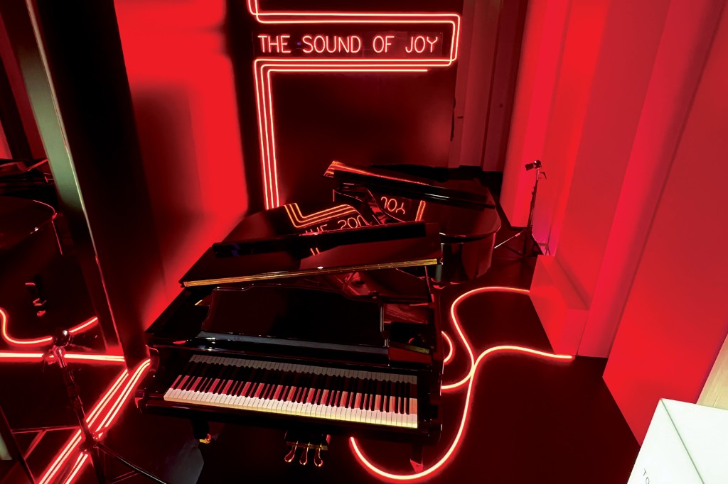 Make it Real — The Sound of Joy: self-playing grand piano surrounded by red neon