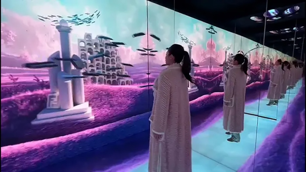 Masters of Materials — visitor inside the mirrored room with projected dreamscape