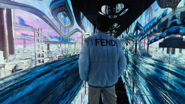 Masters of Materials — guest in a Fendi jacket inside an icy blue world of flowing rivers and architecture