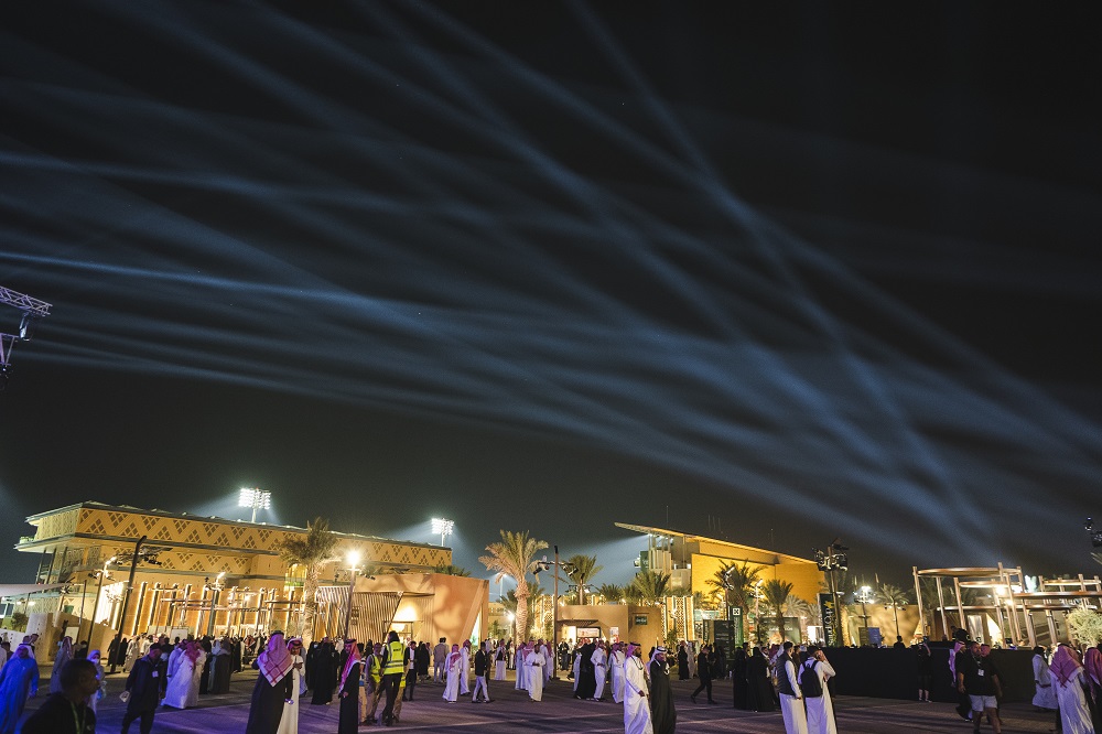 Saudi Cup — night-time crowd in the event village under searchlights